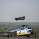 Kyzyl airport. Mi-8 on parking with An-2 landing on background
